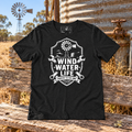 Wind Water Life Tee beside a rural Australian windmill and water tank