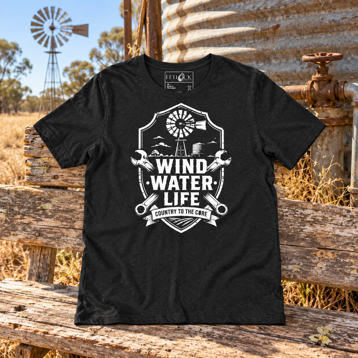 Wind Water Life Tee beside a rural Australian windmill and water tank